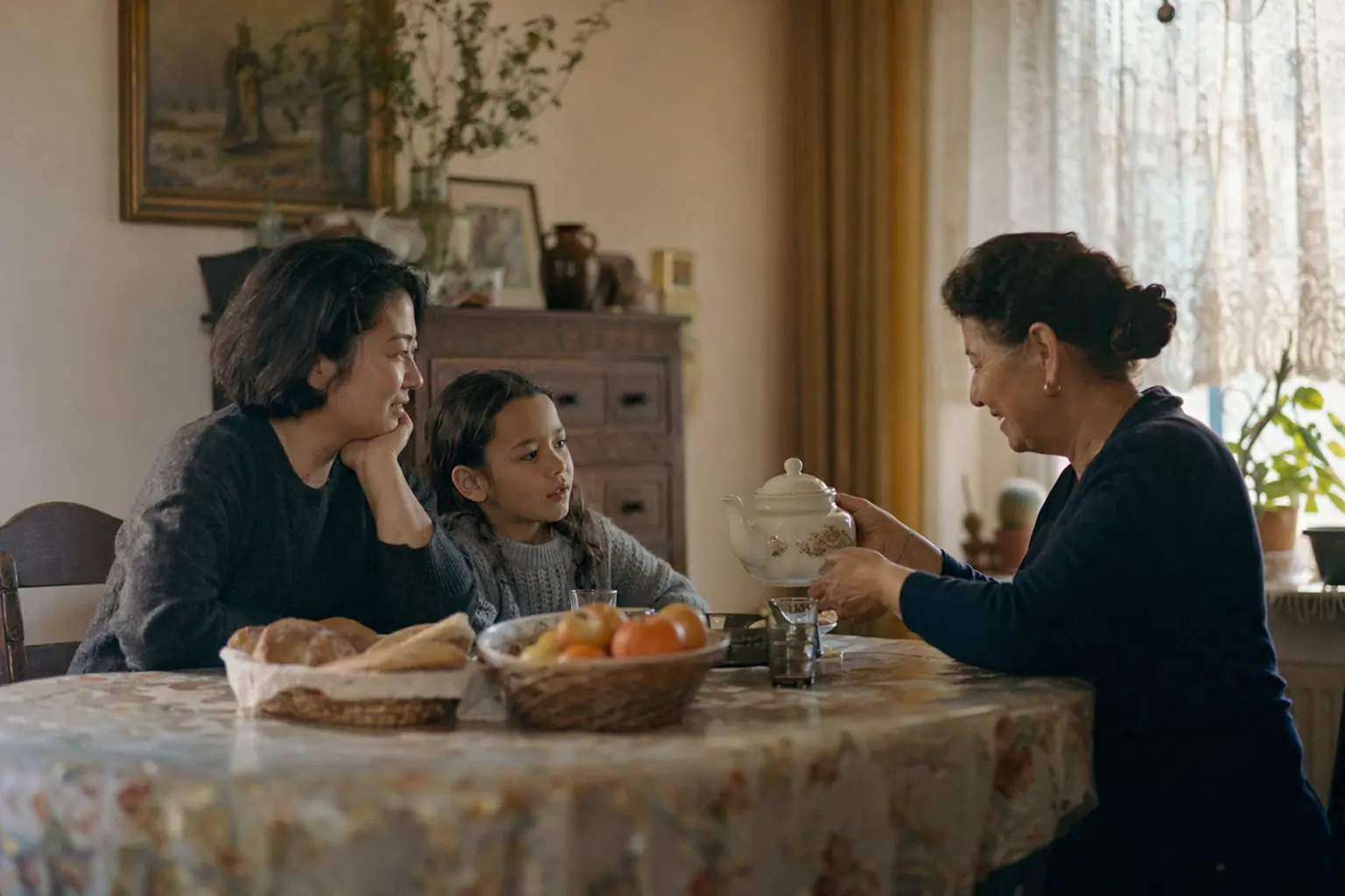 Women talking over tea around a kitchen table